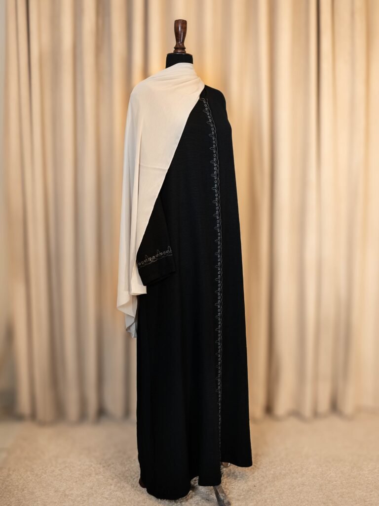 Black İNCİ embroidered Turkish abaya, full-length front view with a white hijab