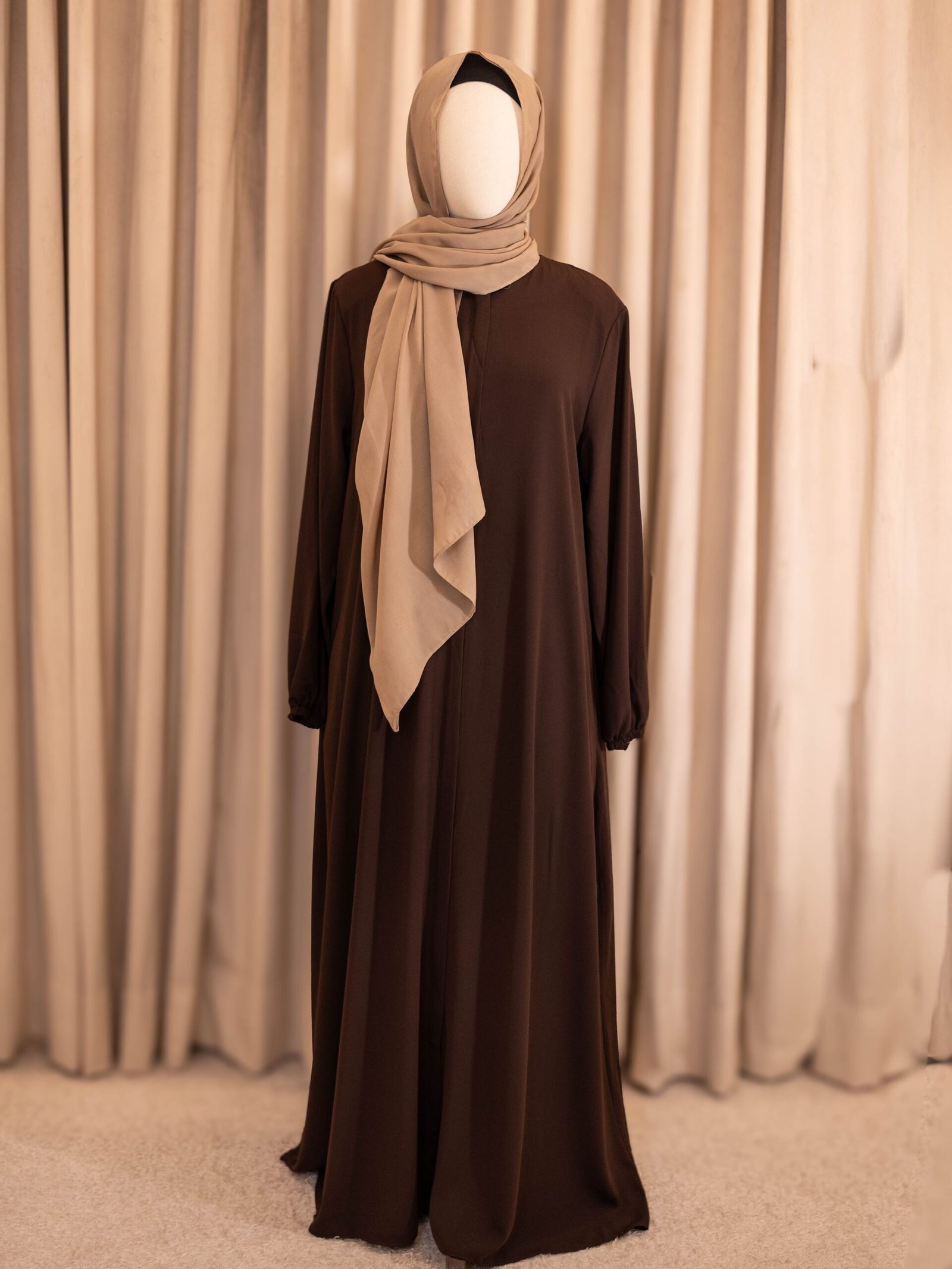Brown Selma everyday Turkish abaya in matte nida, full-length front view with a beige hijab