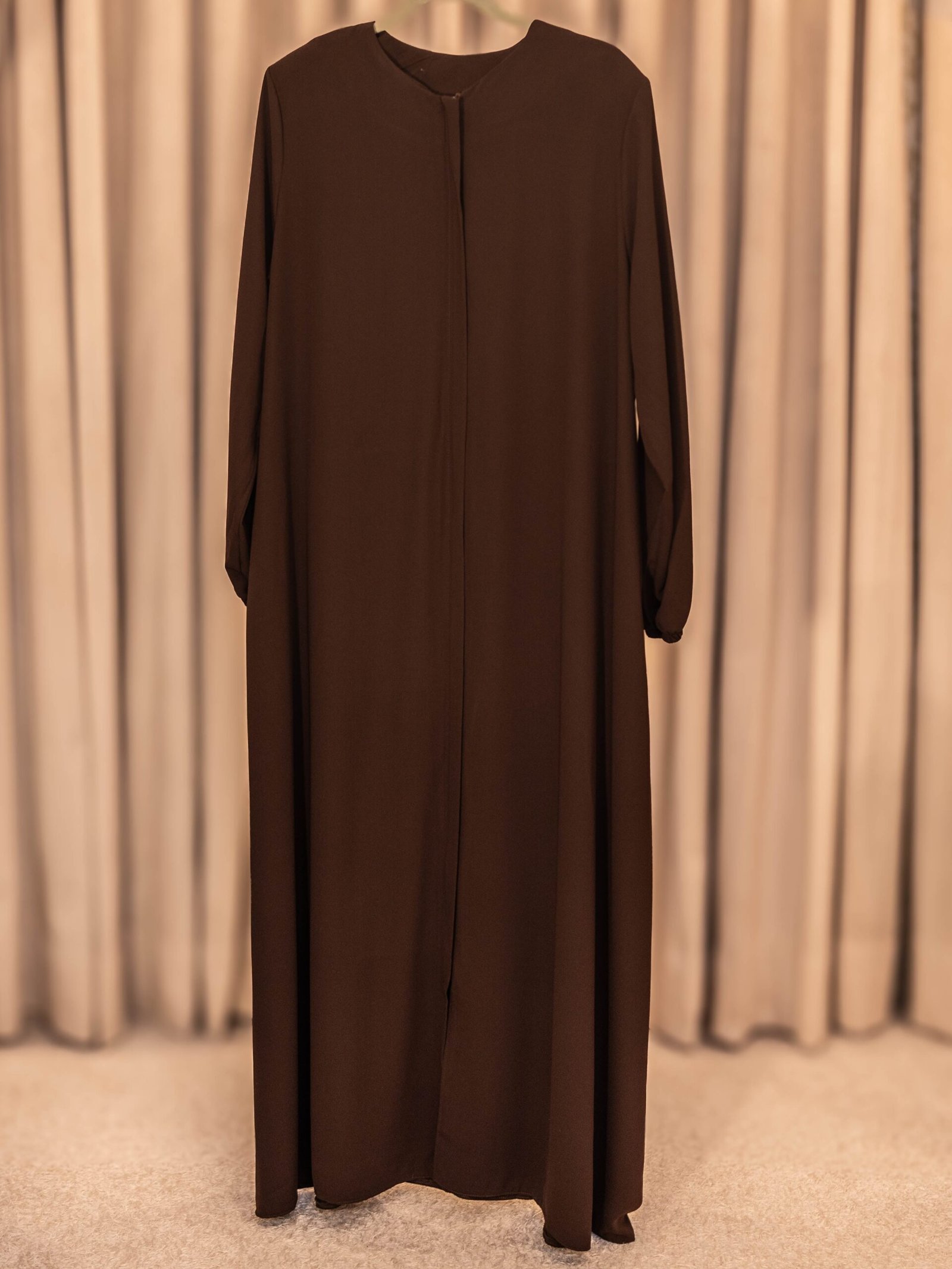 Brown Selma everyday Turkish abaya in matte nida, full length on a hanger