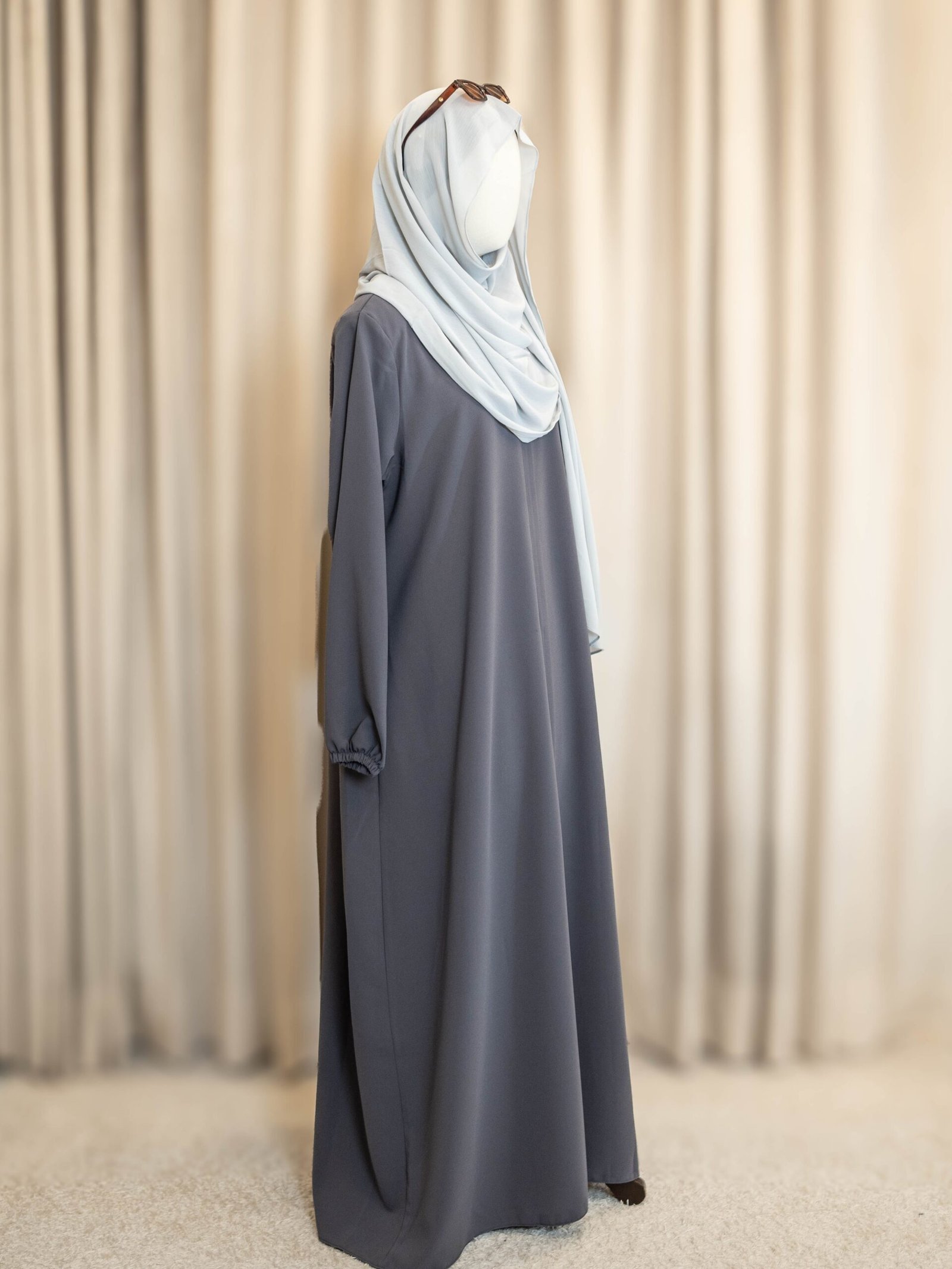 Grey Selma Winter Turkish abaya in waffle-weave cotton, side view with a pale blue hijab